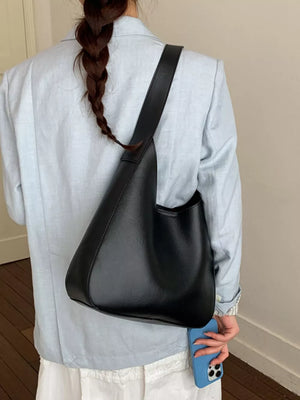 Black pu leather shoulder bag with a sleek, minimalist design.