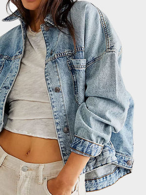 Light wash oversized denim trucker jacket with button front and cuffs.