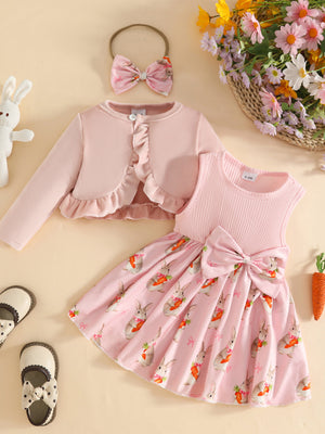 Pink baby dress with bunny and carrot print, ruffled cardigan, and bow headband.
