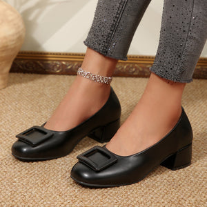 Black buckle block heel shoes with a square toe and chunky heel.