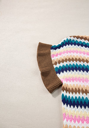 Textured knit sweater with multicolor diamond pattern and brown contrast trim sleeve detail.