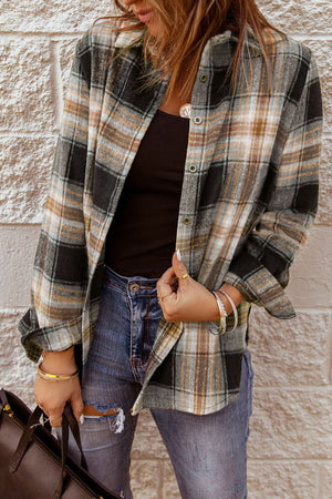 Oversized black plaid shacket with button front, worn open over a black tank top.