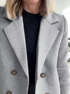 Gray double-breasted wool blend blazer with button detail and ribbed sleeves.