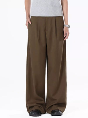 Men's brown flowy wide-leg sweatpants with pleats and pockets.