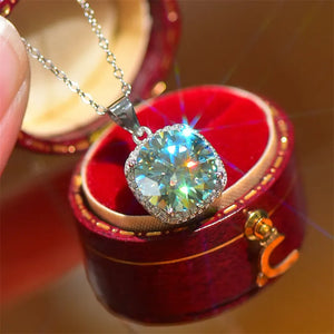 Silver cushion-cut moissanite halo pendant necklace in a jewelry box