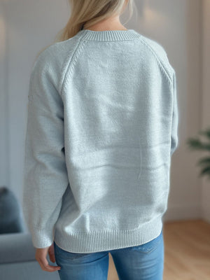 Pastel blue knit sweater with raglan sleeves and crew neck, ribbed cuffs and hem.