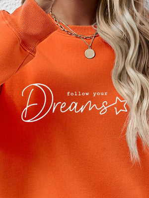 Dreams Scripted Oversized Sweatshirt in Pumpkin orange with white text detail.