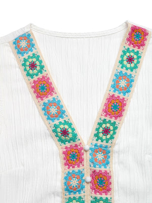 White V-neck blouse with colorful crochet trim and button detail