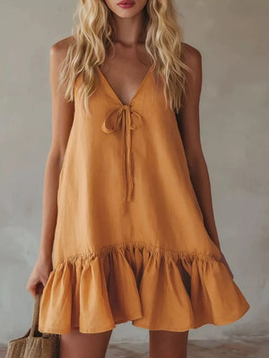 Turmeric tie-front mini dress with V-neck and ruffle hem.