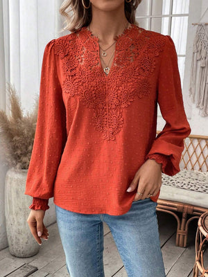 Orange-red blouse with lace yoke and puff sleeves