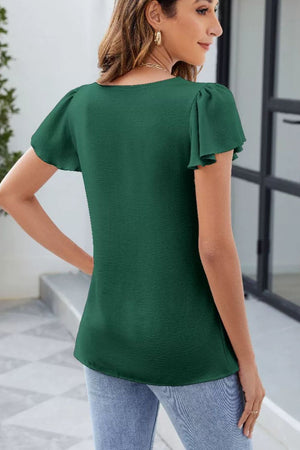Dark green ruffled square neck blouse with flutter sleeves and textured fabric.