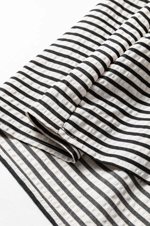 Chic black and white striped cotton midi dress with pockets detail.