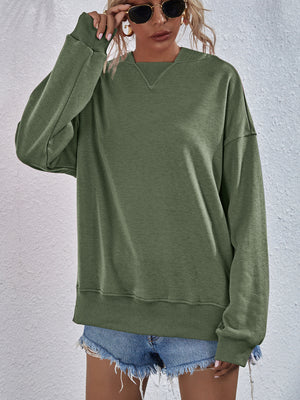 Moss green boxy sweatshirt with V-neck detail and ribbed cuffs and hem.