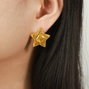 Gold textured celestial star stud earrings with a diamond pattern detail.