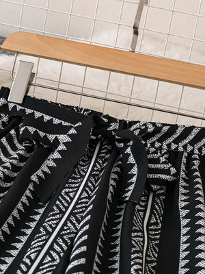 Black geometric print maternity pants with adjustable tie bow detail