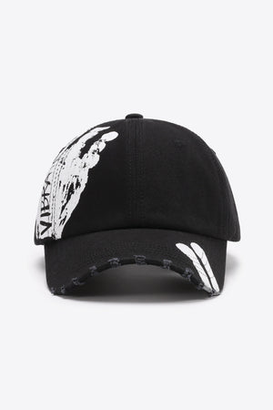 Black baseball cap with white graffiti art and distressed brim