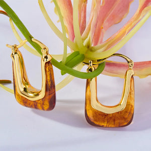 Gold geometric hoop earrings with amber resin detail
