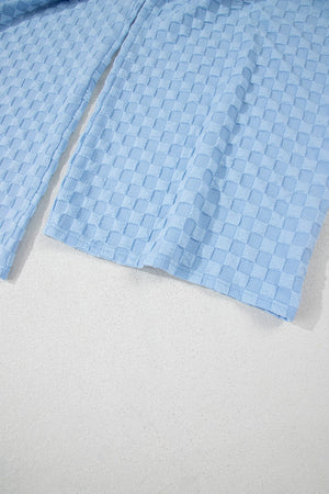 Light blue textured checkered button-strap palazzo jumpsuit detail