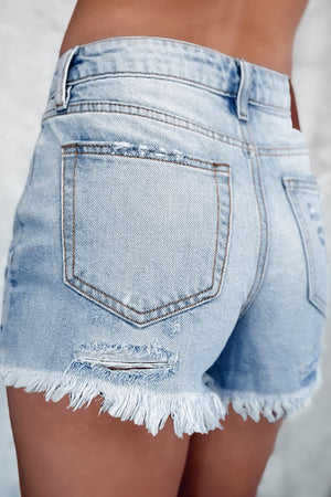 Light blue denim cutoff shorts with distressed details and frayed hem