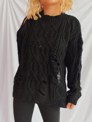 Black distressed cable knit sweater with ripped details and cut-out shoulder.