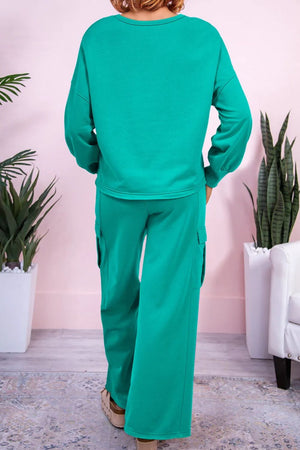 Turquoise loungewear set with relaxed fit sweatshirt and cargo pocket pants.