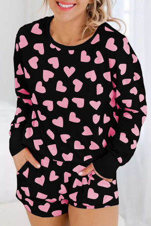 Black heart print pajama set with long sleeves and shorts.