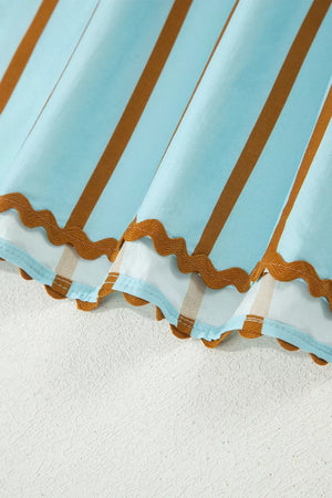 Light blue cotton blend blouse with brown stripes and scalloped hem detail.