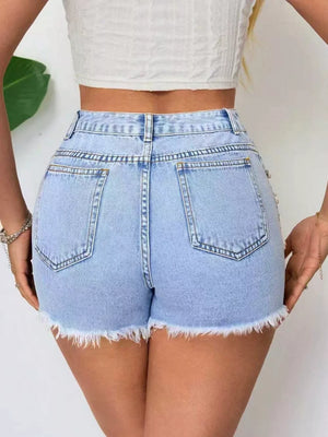Light wash denim shorts with frayed hem and distressed details.
