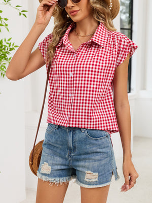 Red gingham cotton shirt with cap sleeves and button-down front, styled with denim shorts.