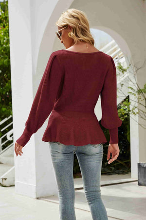 Burgundy ribbed knit peplum top with voluminous sleeves and a scoop neckline.