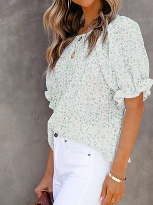 Maternity blouse in green floral print polyester with smocked bodice and ruffle sleeves.