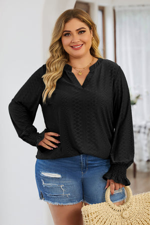 Black textured slit-neck blouse with shirred cuffs and long sleeves.