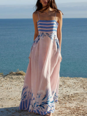Pink maxi dress with spaghetti straps, blue stripes on bustier, and abstract blue print on skirt.