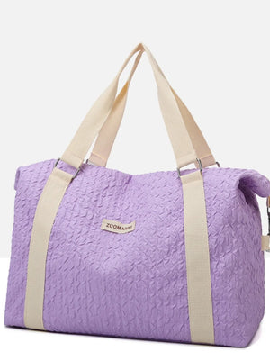 Lavender waffle-weave weekend bag with cream straps and silver hardware.