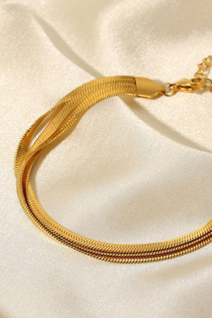 Gold triple herringbone chain bracelet with a flat, sleek design.