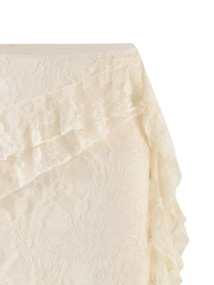 Cream lace ruffled mini skirt with asymmetrical hem detail.