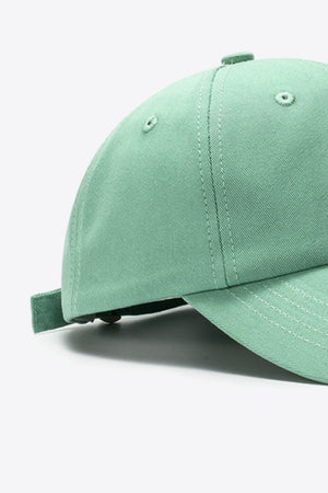 Green cotton baseball cap with adjustable strap detail