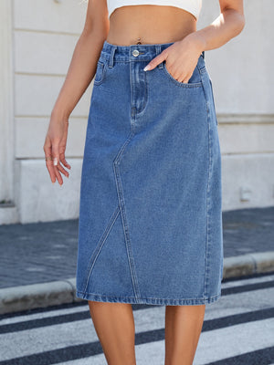 Light blue denim midi skirt with panel seams and front pockets.