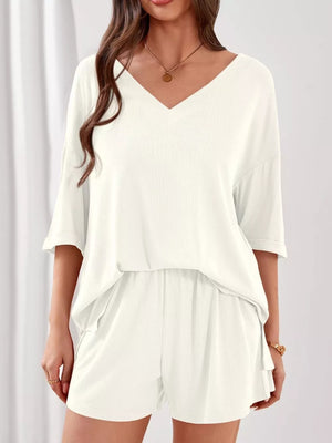 Ivory V-neck loungewear set with relaxed fit top and elastic waist shorts.