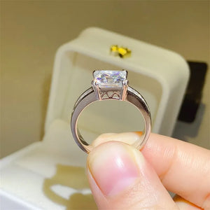 Princess cut engagement ring with baguette band in silver.