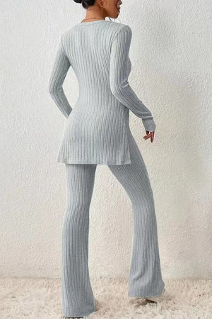 Light gray ribbed knit co-ord set with flared pants and tunic top with side slit.
