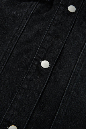 Black denim trucker jacket with silver buttons and detailed stitching.