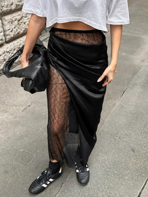 Black midi skirt with sheer lace panels and asymmetrical wrap detail.