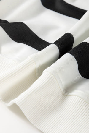 Black and white striped loungewear set with ribbed cuffs and hem detail.