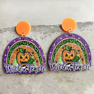 Spooky teacher rainbow earrings with pumpkins and text Trick or Teach, acrylic.