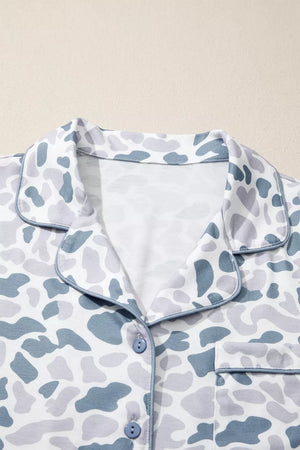 Blue camouflage print button-down pajama top with piped trim and chest pocket.