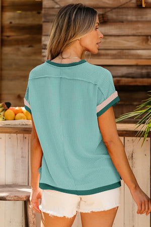 Ribbed colorblock tee in teal with pink and green trim on sleeves and hem.