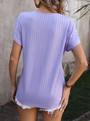 Lavender textured tee with short sleeves and a V-neck, styled with white shorts.
