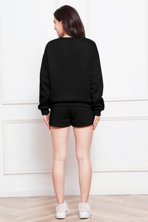 Black crewneck sweatshirt and pocket shorts loungewear set worn by a woman.