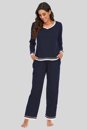 Dark navy V-neck long sleeve pajama set with white trim and striped cuffs.